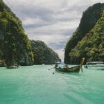 four wooden boat on teal sea