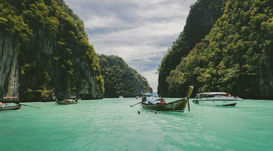 four wooden boat on teal sea