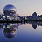 Grey Dome Building Beside Body of Water during Sunset