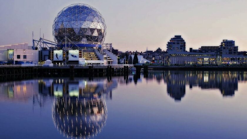 Grey Dome Building Beside Body of Water during Sunset