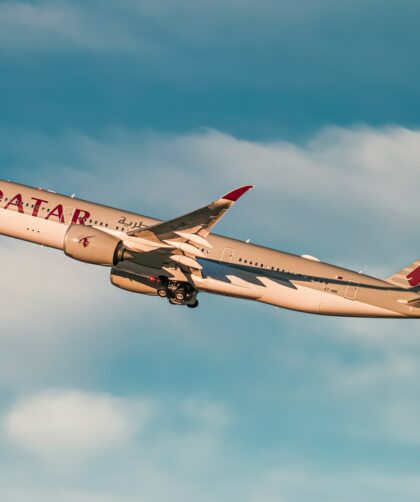 white and red air plane flying in the sky during daytime