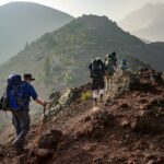 group of person walking in mountain