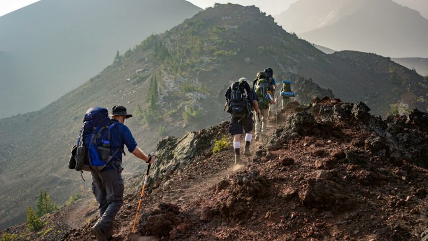 group of person walking in mountain