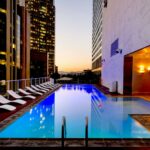 white sunloungers beside pool